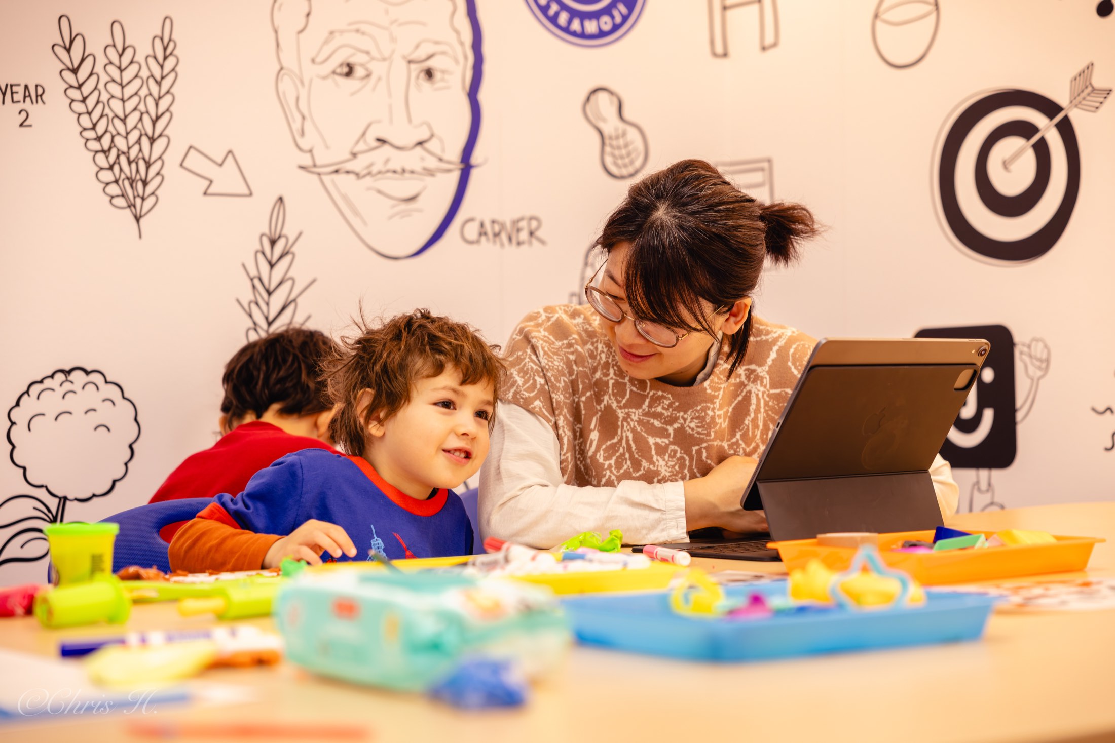 Teacher guiding young kids through a craft and storytelling session